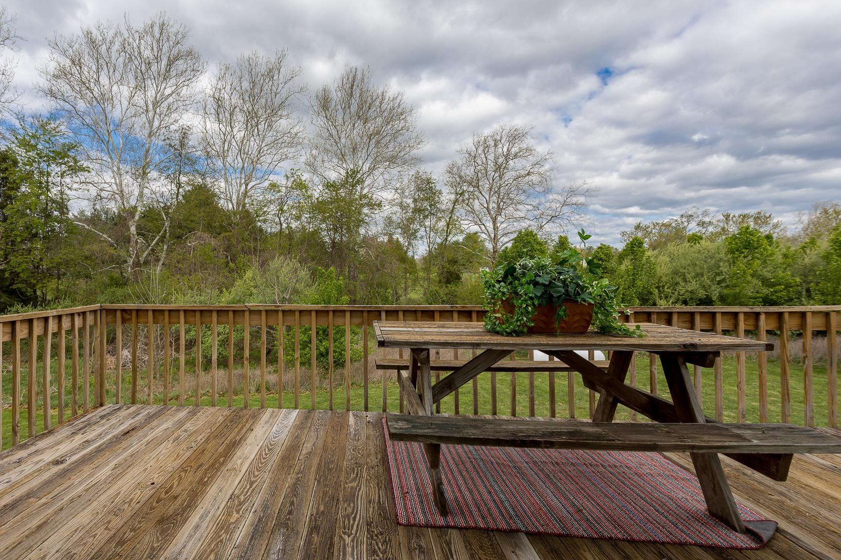 403 Augusta Farms Road Waynesboro, VA 22980 - Photo 54 of 60 a view of a roof deck with table and chairs a barbeque with wooden floor and fence
