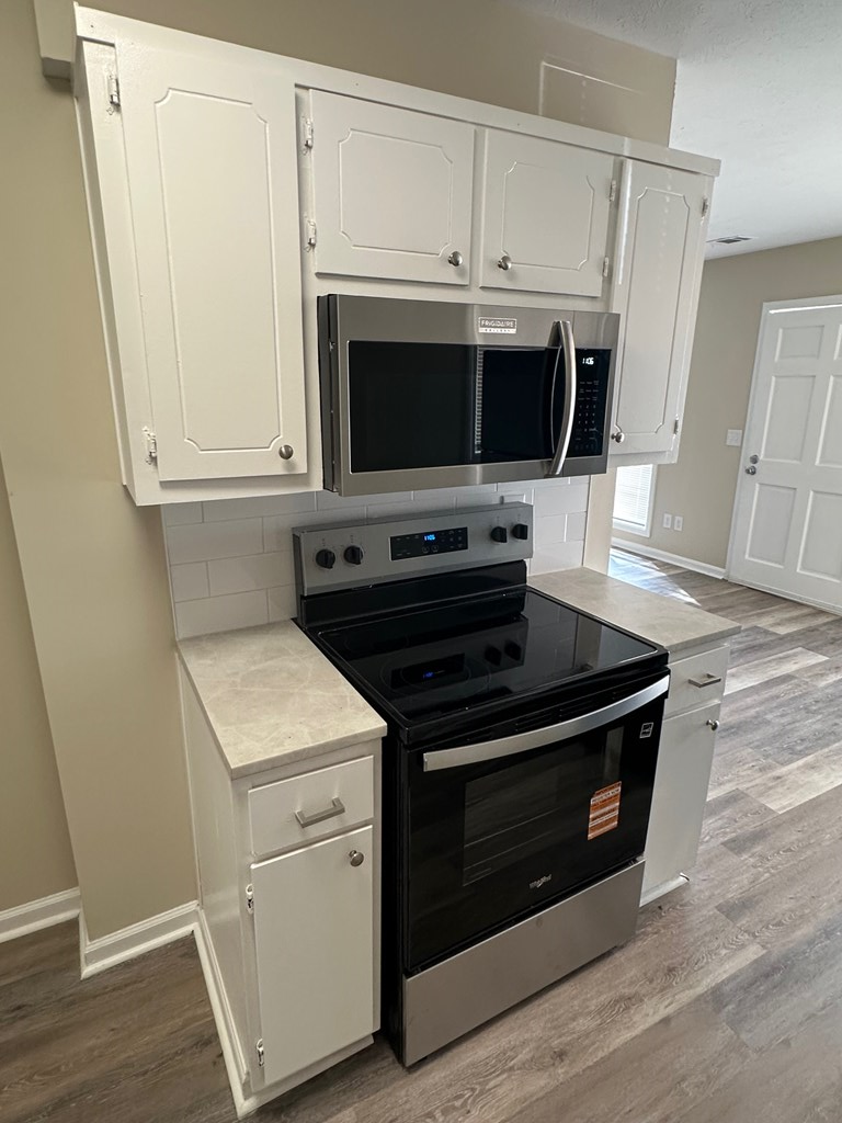 4135 Forrest Road Columbus, GA 31907 - Photo 6 of 15 a kitchen with granite countertop a stove and a microwave
