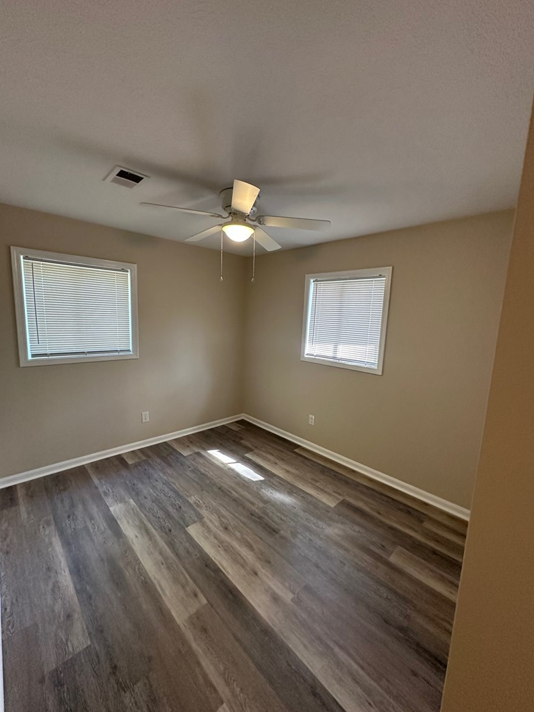 4135 Forrest Road Columbus, GA 31907 - Photo 8 of 15 a view of an empty room with wooden floor and a window