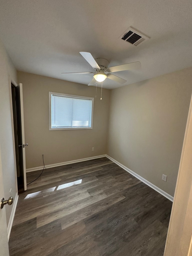 4135 Forrest Road Columbus, GA 31907 - Photo 9 of 15 a view of an empty room with wooden floor and a window