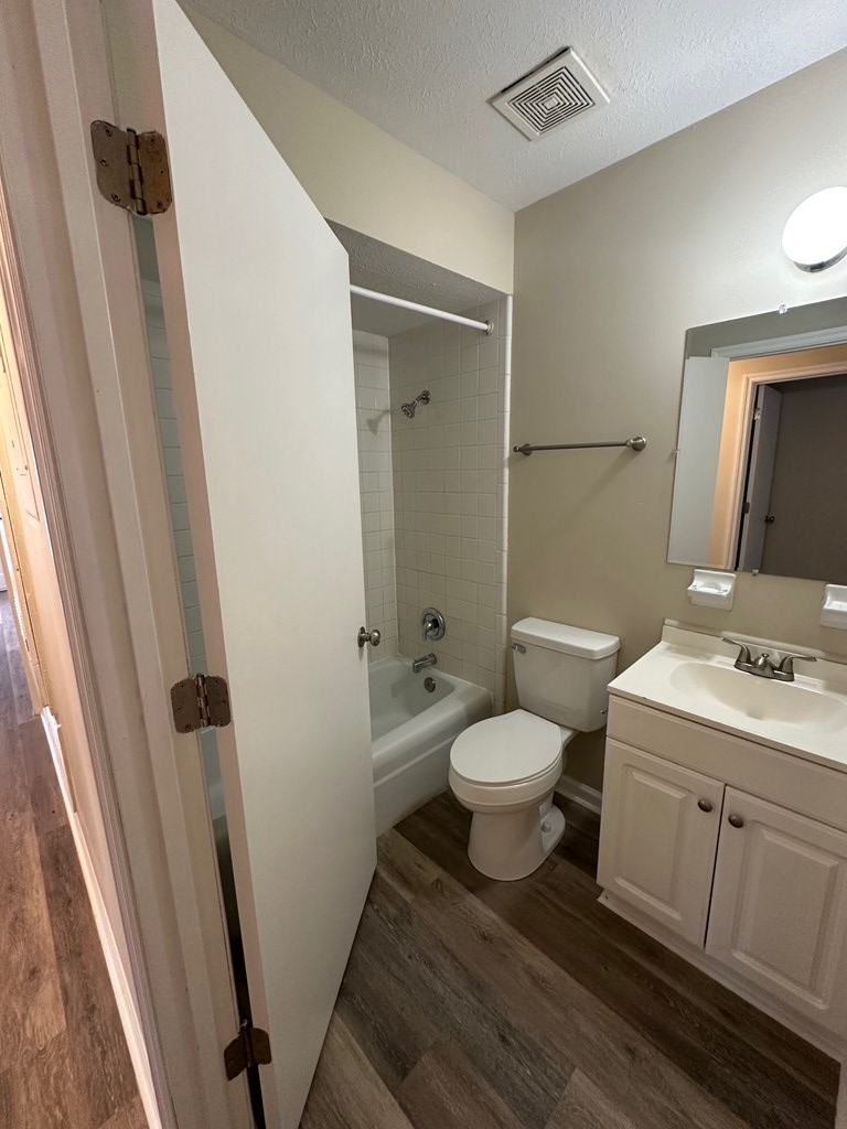 4135 Forrest Road Columbus, GA 31907 - Photo 10 of 15 a bathroom with a granite countertop toilet sink and a mirror