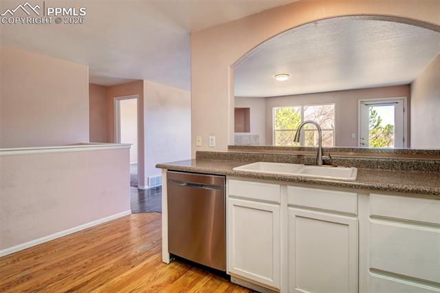 3579 Indigo Ridge Point Colorado Springs, CO 80910 - Photo 5 of 33 Kitchen with wood floors, stainless steel appliances and ample cabinet space