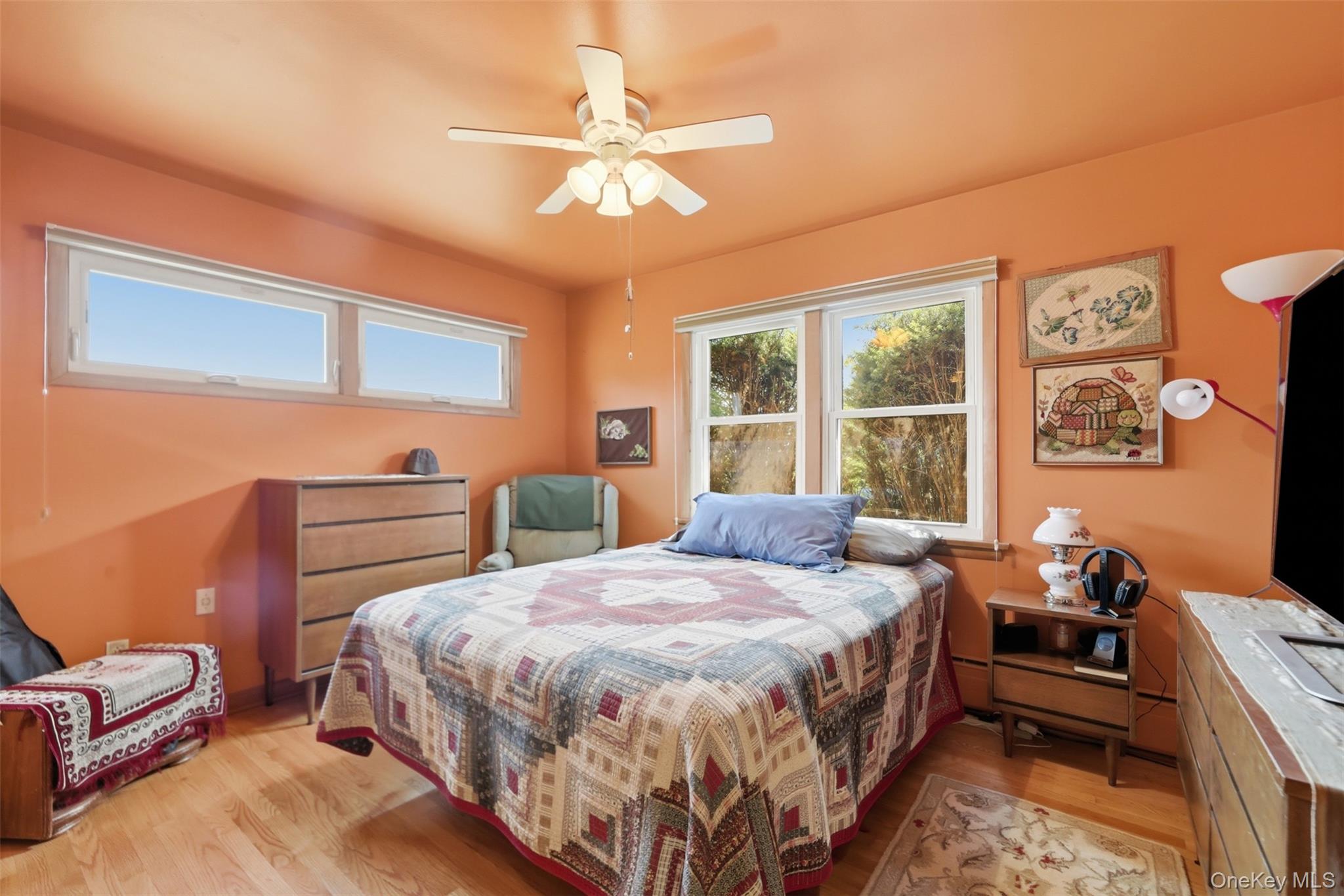 1 Hiko Place Fishkill, NY 12524 - Photo 21 of 41 Bedroom featuring wood-finish flooring, a ceiling fan with integrated lighting, and multiple windows
