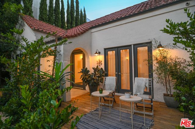 a front view of a house with outdoor seating and green space