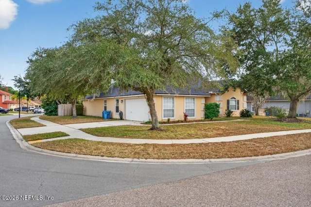 a view of a house with a yard and garage