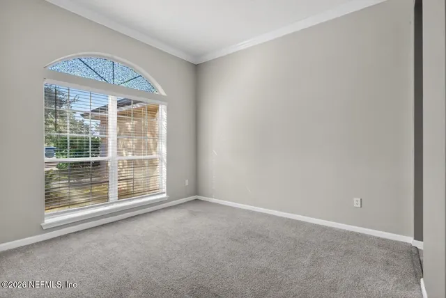 a view of a room with an empty space and wooden floor