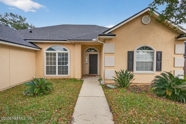 a front view of a house with garden