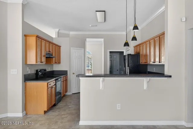 a kitchen with granite countertop wooden cabinets and a stove top oven