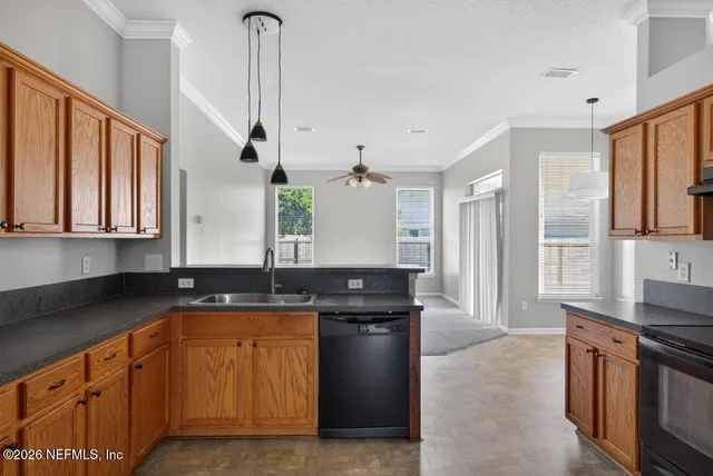 a view of a kitchen cabinets and a refrigerator