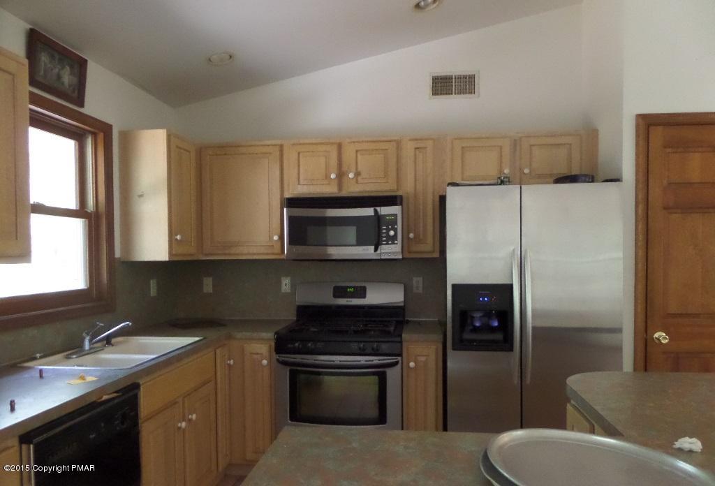 280 Pin Oak Road Stroudsburg, PA 18360 - Photo 12 of 14 a kitchen with a refrigerator stove and sink