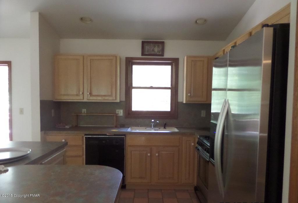 280 Pin Oak Road Stroudsburg, PA 18360 - Photo 13 of 14 a kitchen with a sink a window and stainless steel appliances