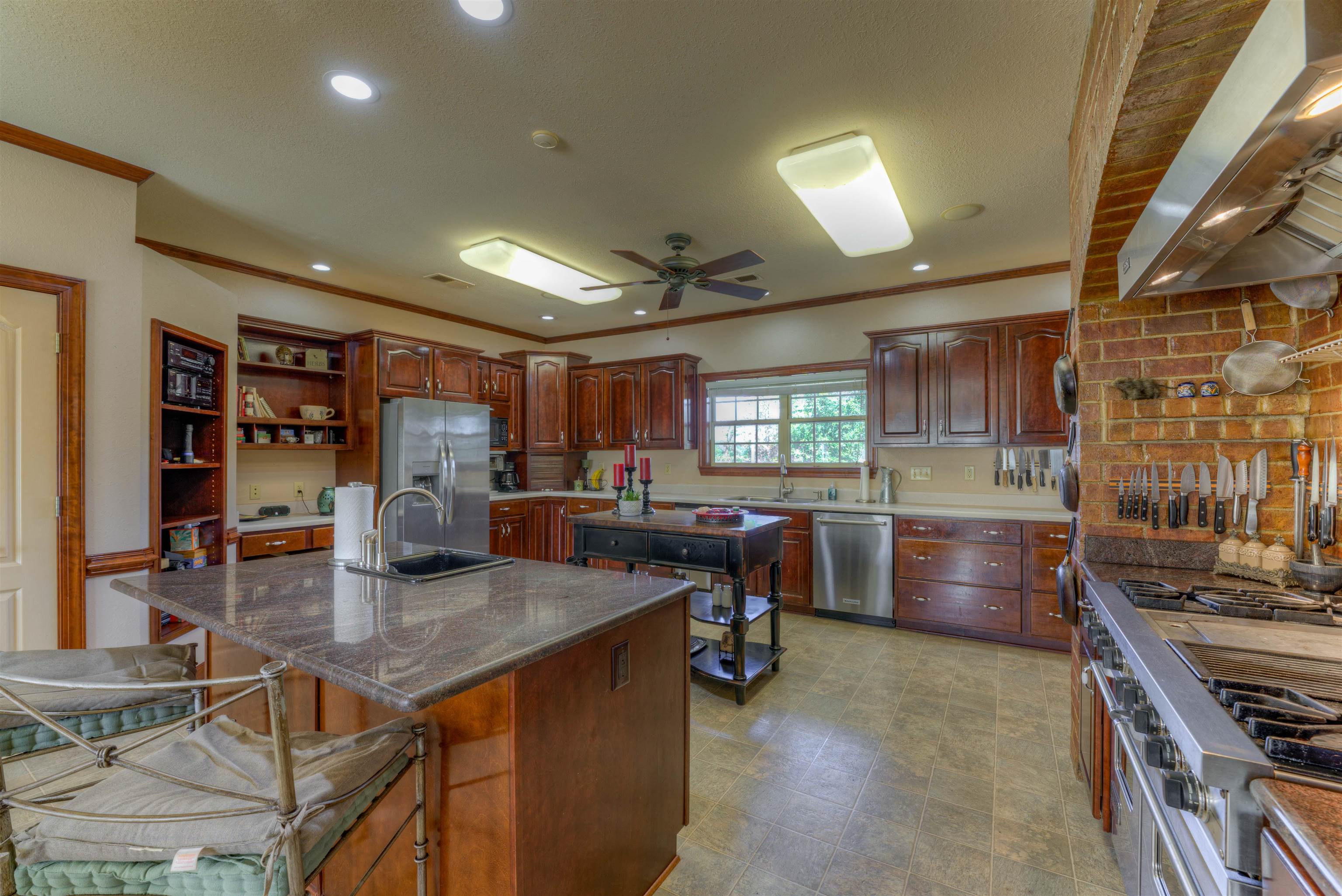 10529 Moose Road Millington, TN 38053 - Photo 19 of 40 a kitchen with stainless steel appliances granite countertop a stove and a refrigerator