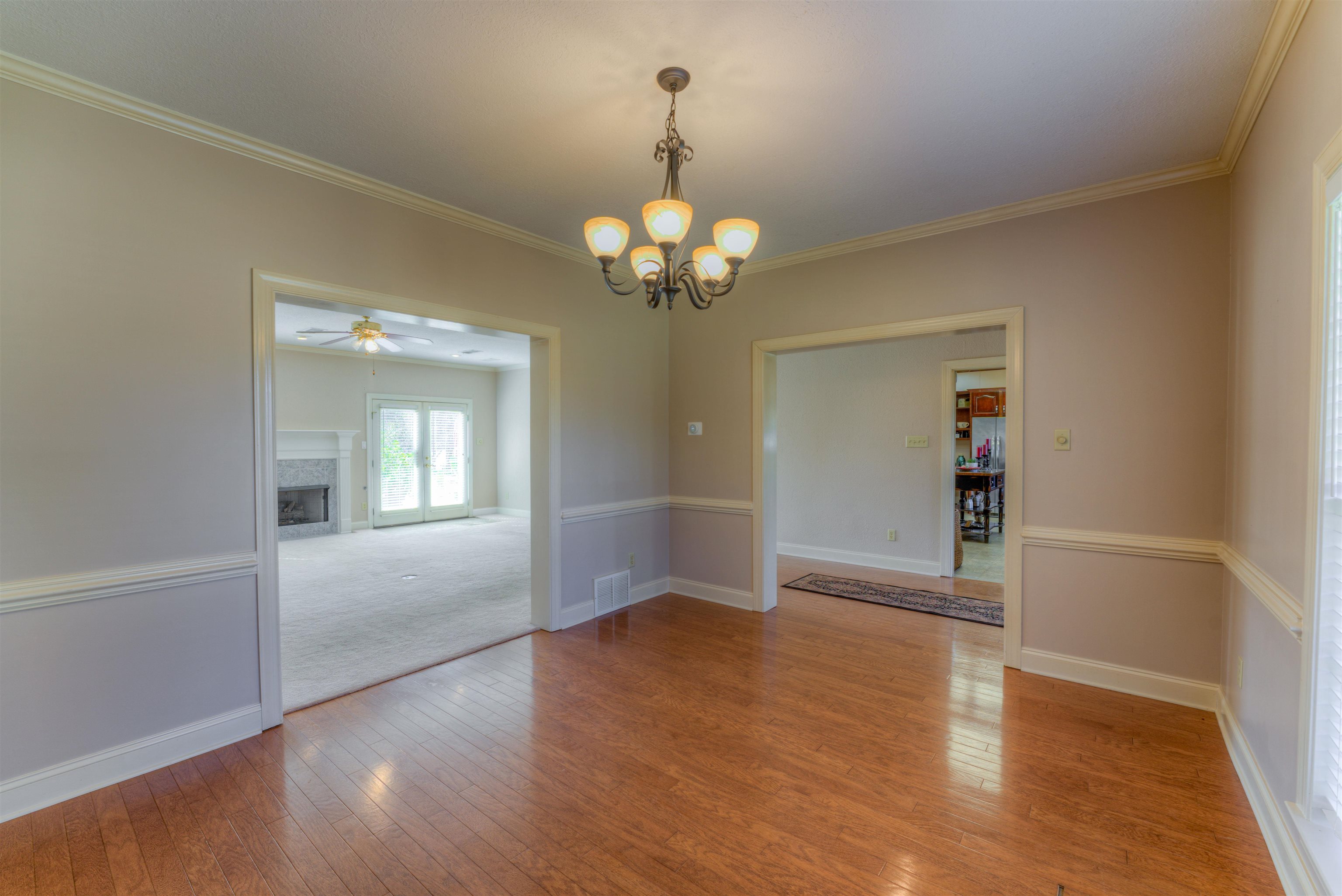 10529 Moose Road Millington, TN 38053 - Photo 27 of 40 an empty room with wooden floor chandelier and windows