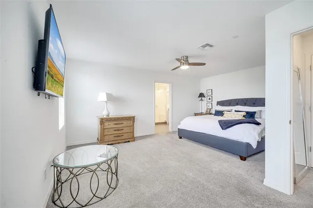 a bedroom with furniture and a flat screen tv