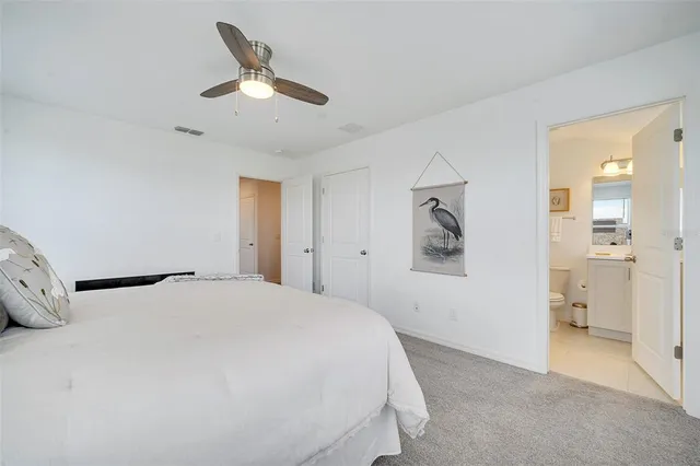 a bedroom with a bed and a large mirror