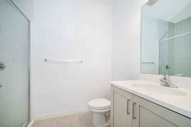 a bathroom with a sink toilet and a mirror