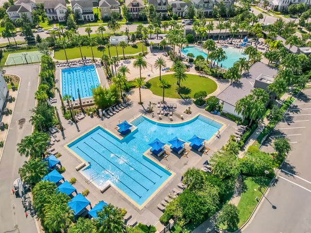 an aerial view of a house with garden space and lake view