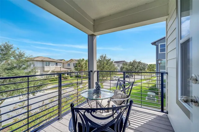 a view of a balcony with lake view and wooden floor
