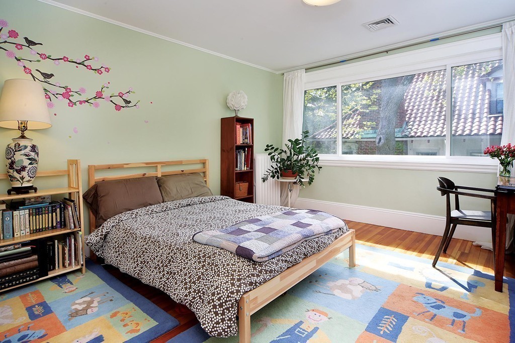 69 Winthrop Road, Unit 69 Brookline, MA 02445 - Photo 14 of 14 a bedroom with a bed and a table in it