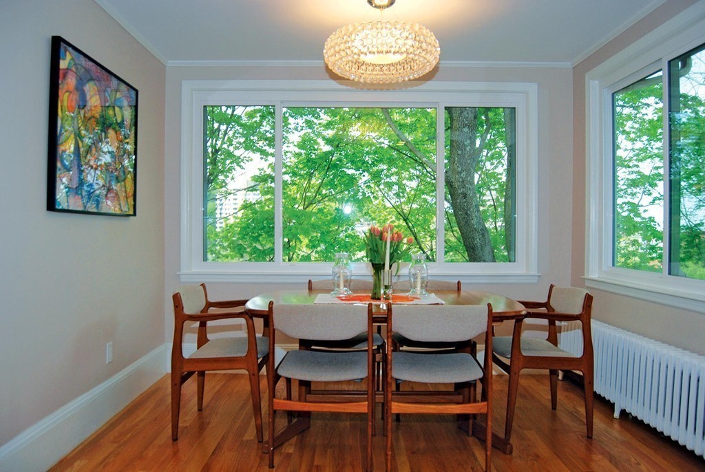 69 Winthrop Road, Unit 69 Brookline, MA 02445 - Photo 8 of 14 a dining room with furniture a large window and outside view
