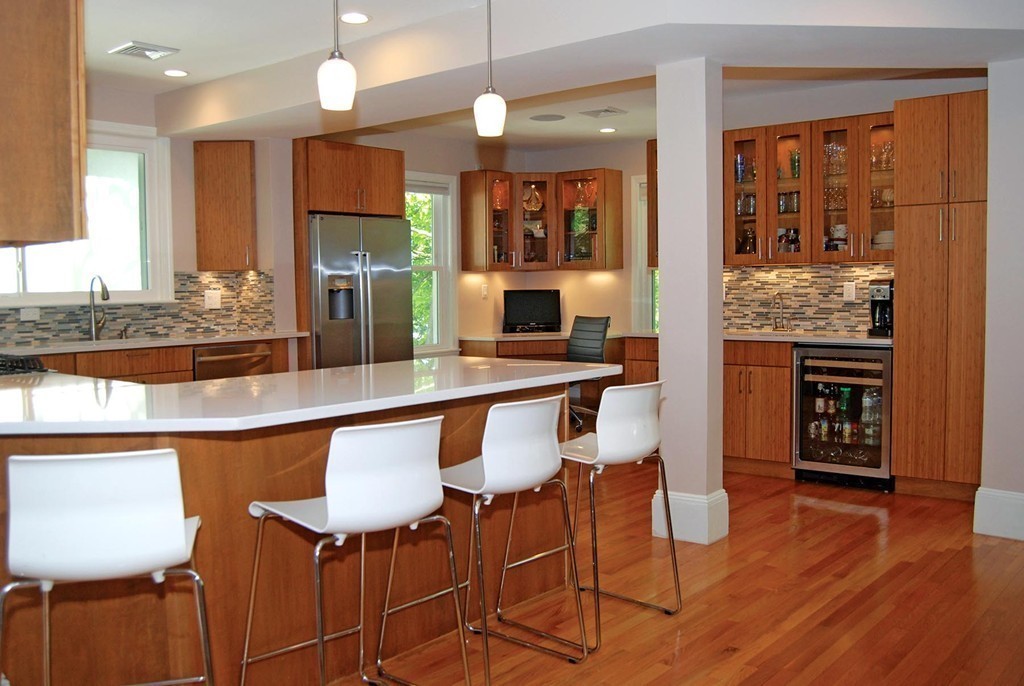 69 Winthrop Road, Unit 69 Brookline, MA 02445 - Photo 9 of 14 a kitchen with a table chairs stove and cabinets