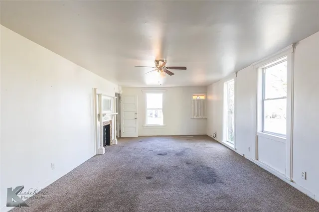 a view of a livingroom with a ceiling fan and window