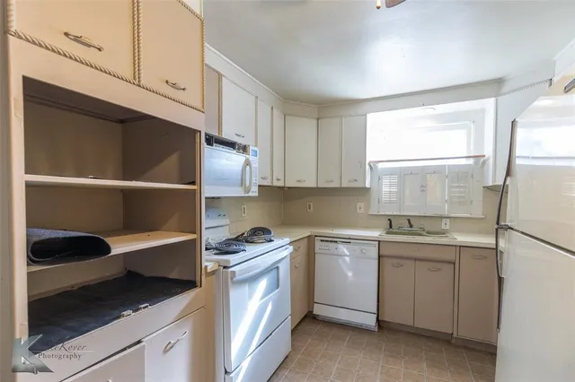 a kitchen with a sink cabinets and window