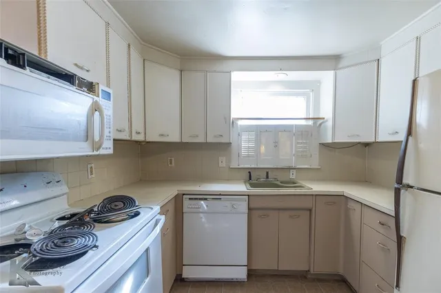 a kitchen with a sink stove and cabinets