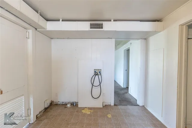 an empty room with a window and a ceiling fan