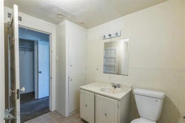 a room with white cabinets and wooden floor