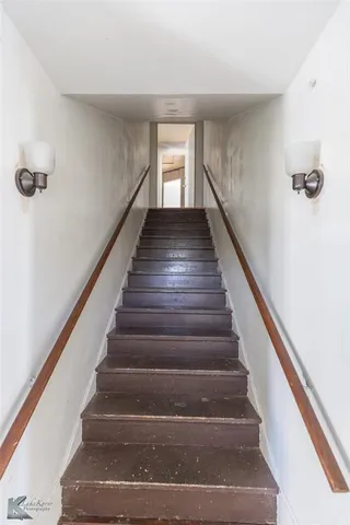 an empty room with a window and a ceiling fan