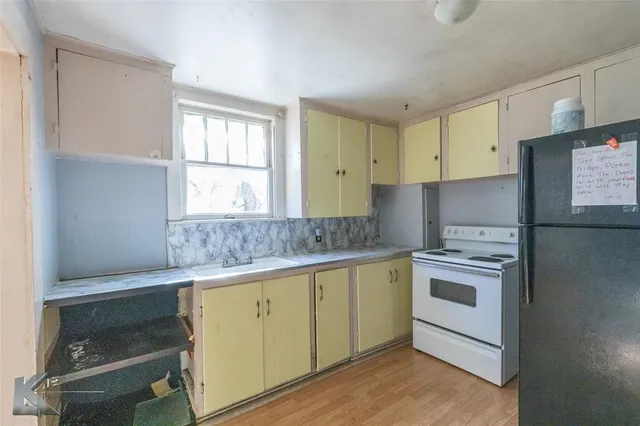 a bathroom with a tub sink and window