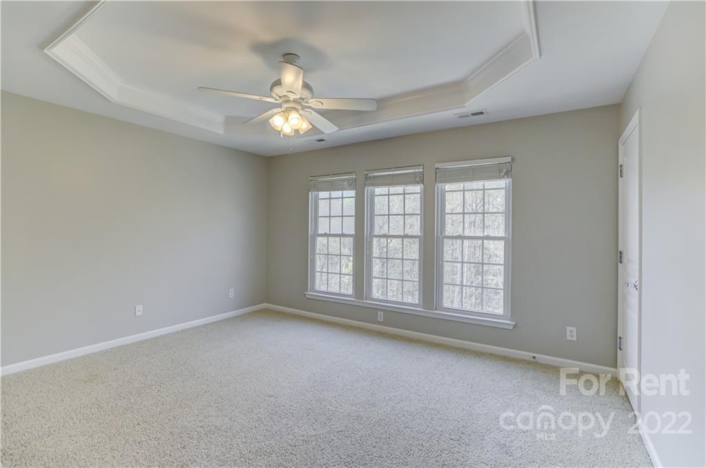 562 6th Baxter Crossing Fort Mill, SC 29708 - Photo 20 of 48 an empty room with chandelier fan and windows