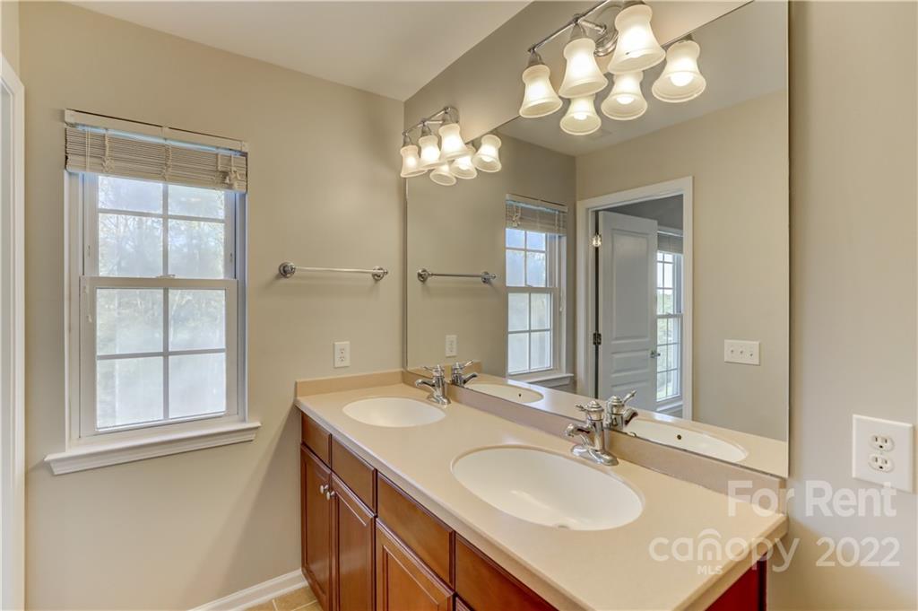 562 6th Baxter Crossing Fort Mill, SC 29708 - Photo 25 of 48 a bathroom with a sink double vanity and a mirror