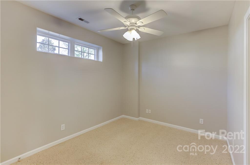 562 6th Baxter Crossing Fort Mill, SC 29708 - Photo 34 of 48 an empty room with windows and chandelier fan