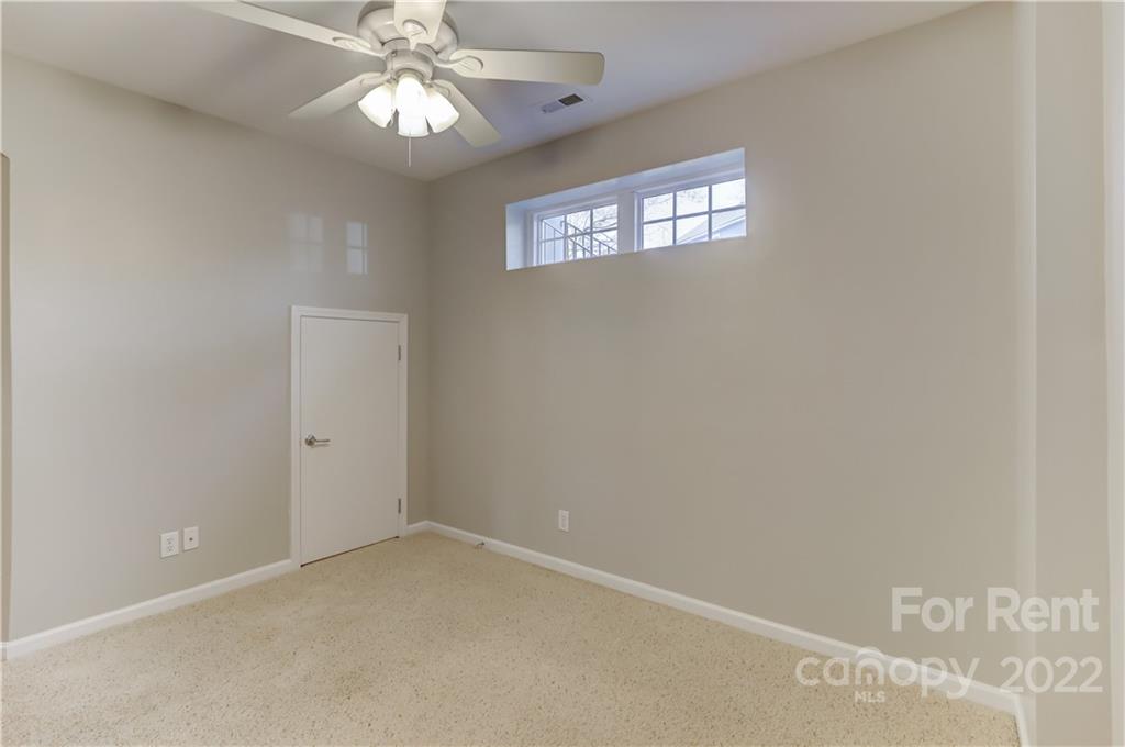 562 6th Baxter Crossing Fort Mill, SC 29708 - Photo 35 of 48 en empty room with windows and ceiling fan