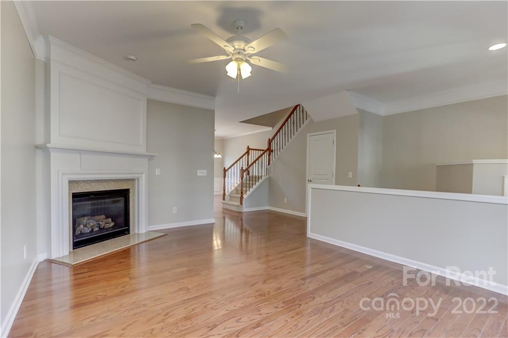 562 6th Baxter Crossing Fort Mill, SC 29708 - Photo 4 of 48 a view of an empty room with wooden floor fireplace and a window