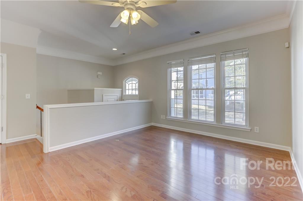 562 6th Baxter Crossing Fort Mill, SC 29708 - Photo 5 of 48 a view of an empty room with wooden floor and a window