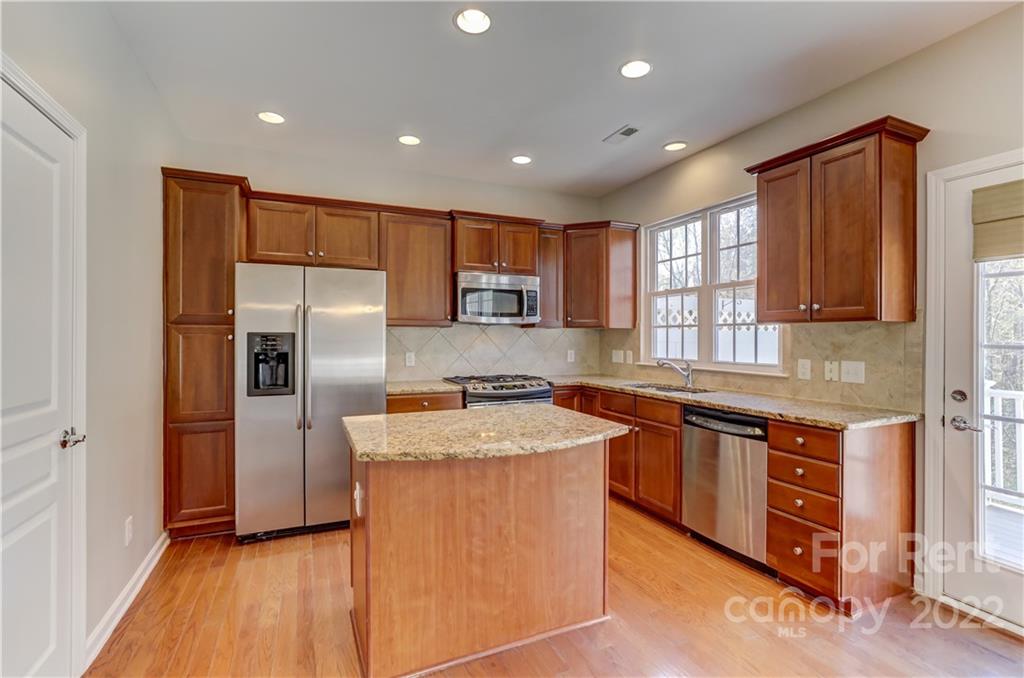 562 6th Baxter Crossing Fort Mill, SC 29708 - Photo 8 of 48 a kitchen with stainless steel appliances granite countertop a refrigerator a sink a stove and oven