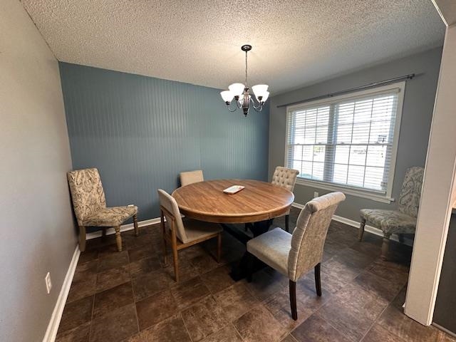 1347 Becton William Road Ripley, TN 38063 - Photo 20 of 24 Dining space with hanging lights, a textured ceiling, and stone finish floors