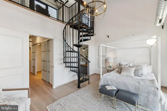 a bedroom with a bed and wooden floor