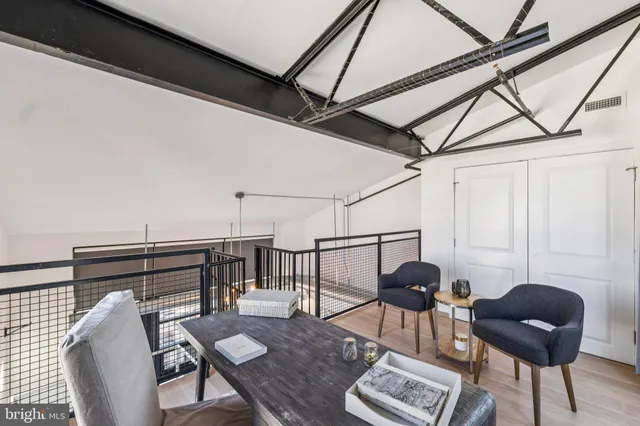 a view of a workspace with furniture and wooden floor