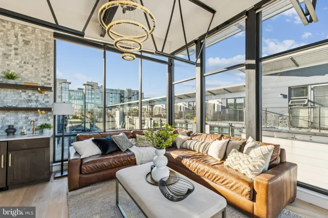 a living room with furniture city view and large windows