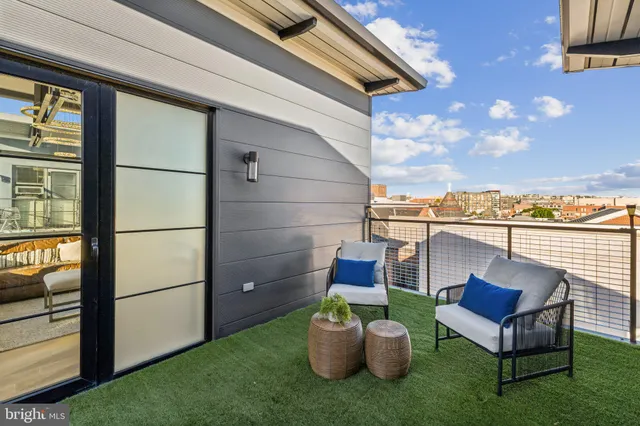 a view of a chair and table in the back yard of the house