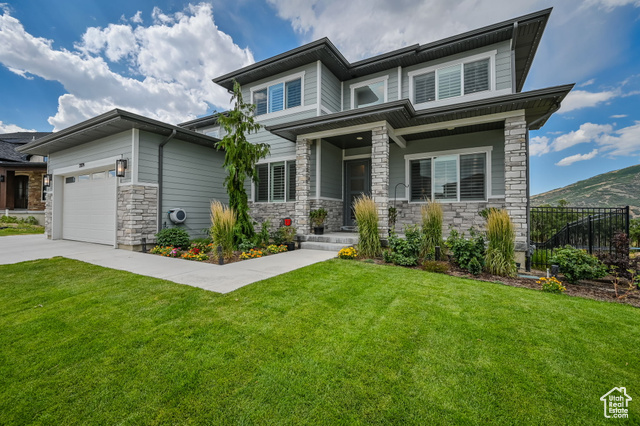 2279 East Ravine Rock Way Draper, UT 84020 - Photo 1 of 1 Prairie-style house featuring stone siding, concrete driveway, and an attached garage