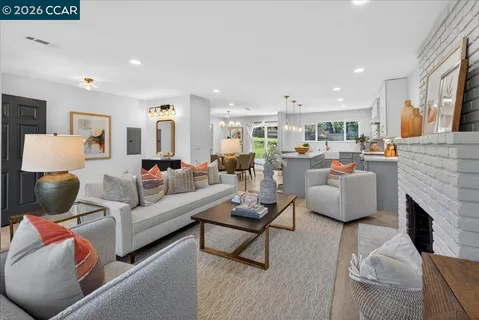 a living room with furniture fireplace and a couch