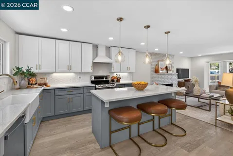 a kitchen with a sink a counter top space appliances and cabinets