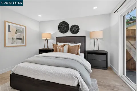 a bedroom with a bed and a painting on the wall