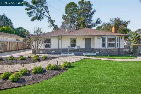 a front view of a house with swimming pool yard and outdoor seating