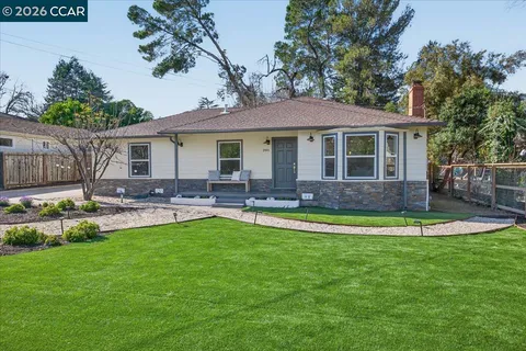 a front view of a house with swimming pool yard and patio
